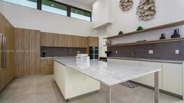 a living room with furniture and a floor to ceiling window