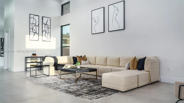 a living room with furniture a rug and a painting