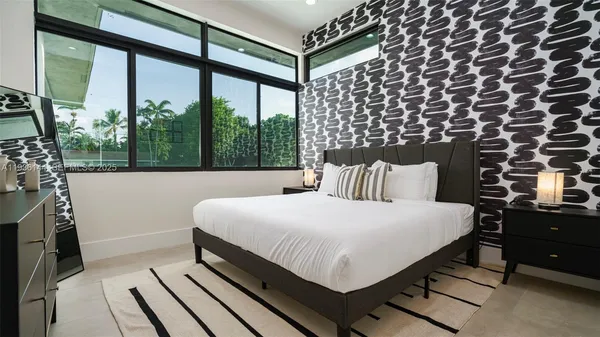 a bedroom with a bed and a couch