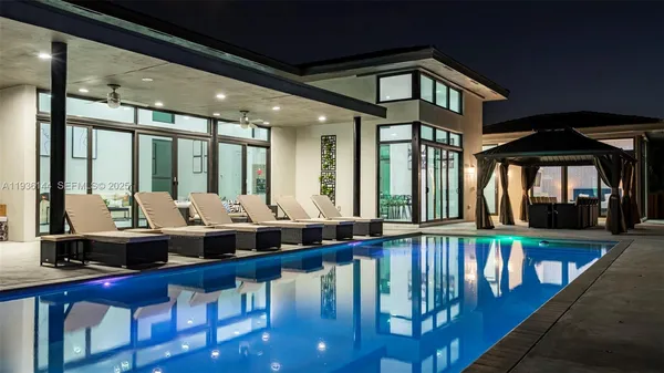 a view of a house with swimming pool and yard