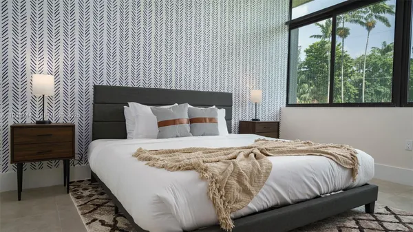 a bedroom with a bed and a window