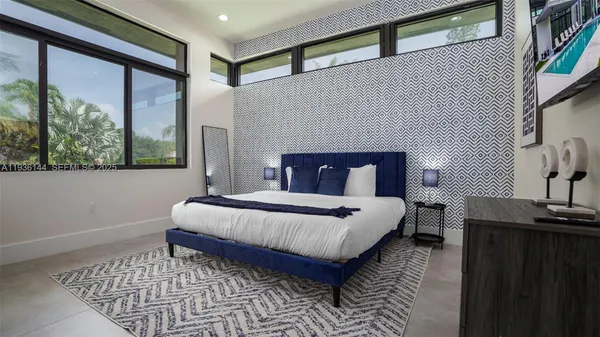 a bed sitting in a bedroom next to a lamp