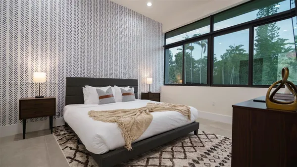 an aerial view of a house with garden space lake view and mountain view in back