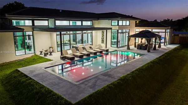 an aerial view of a house with a yard basket ball court and outdoor seating