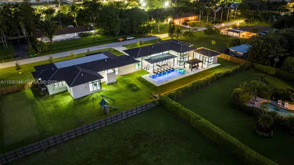 a view of a house with backyard sitting area and garden
