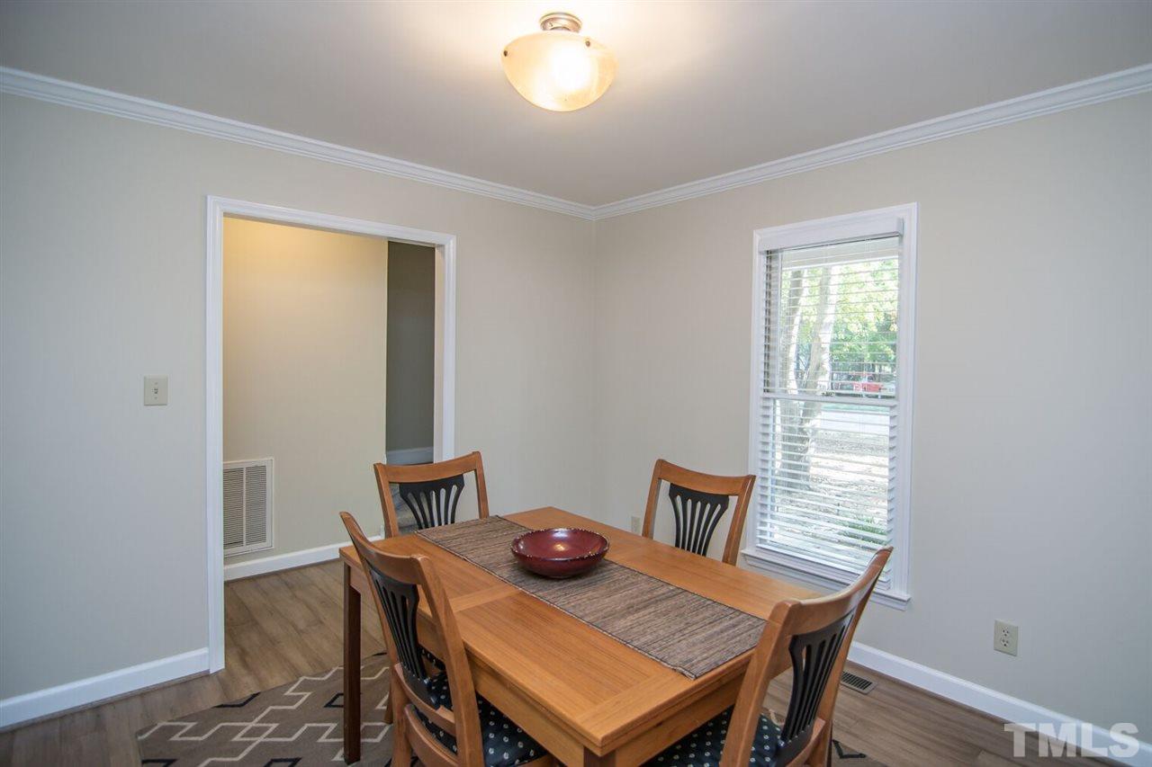 109 Boxford Road Morrisville, NC 27560 - Photo 12 of 27 a view of a dining room with furniture and wooden floor