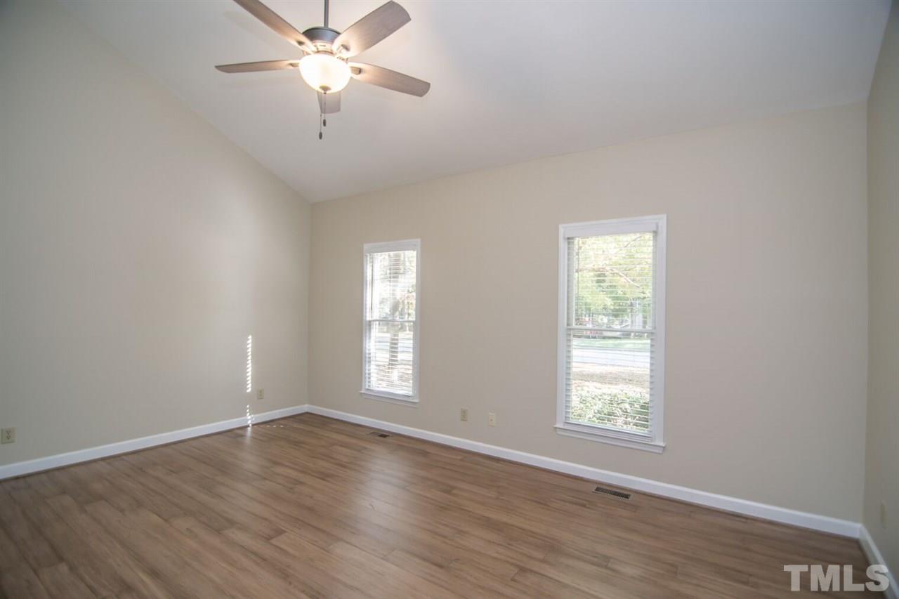109 Boxford Road Morrisville, NC 27560 - Photo 13 of 27 a view of an empty room with a window and wooden floor