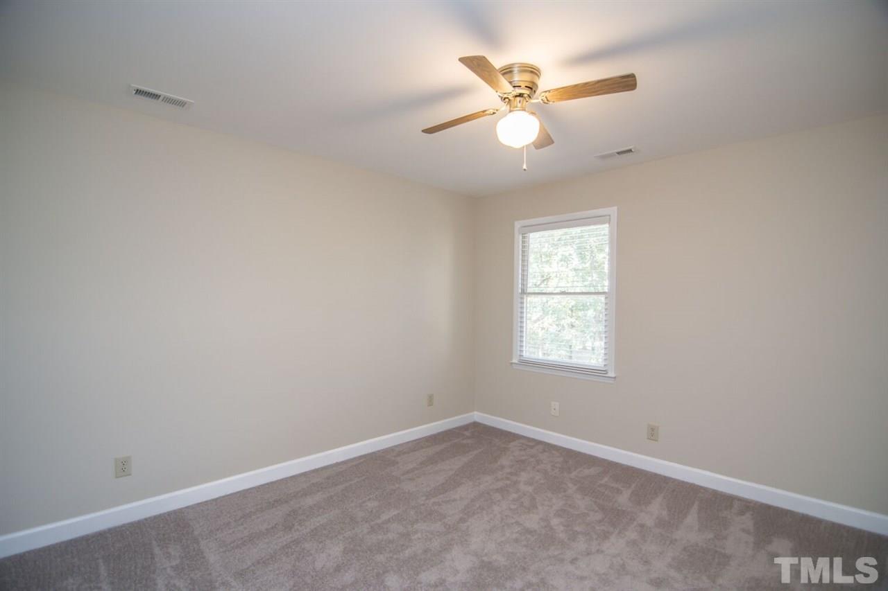 109 Boxford Road Morrisville, NC 27560 - Photo 19 of 27 an empty room with a window and a fan