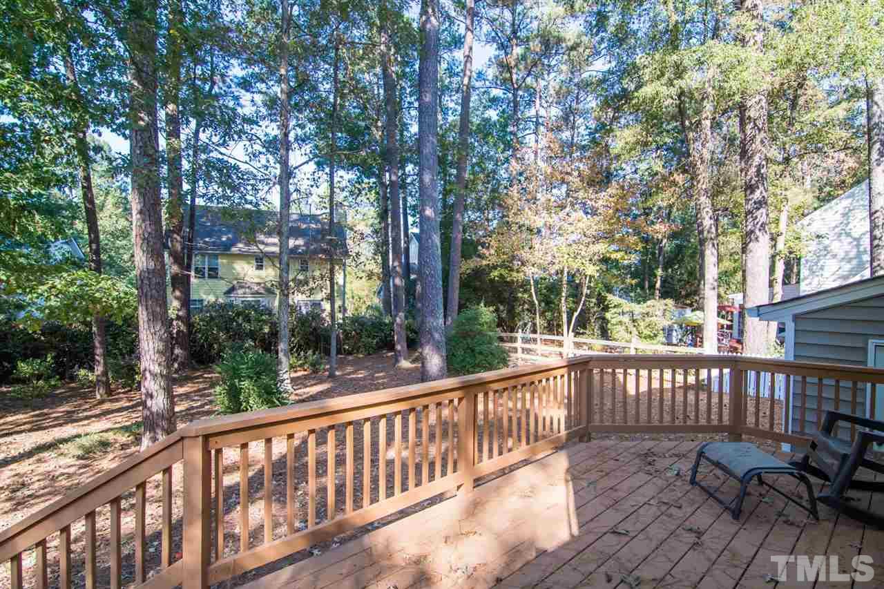 109 Boxford Road Morrisville, NC 27560 - Photo 24 of 27 a view of a wooden deck with chairs and large trees