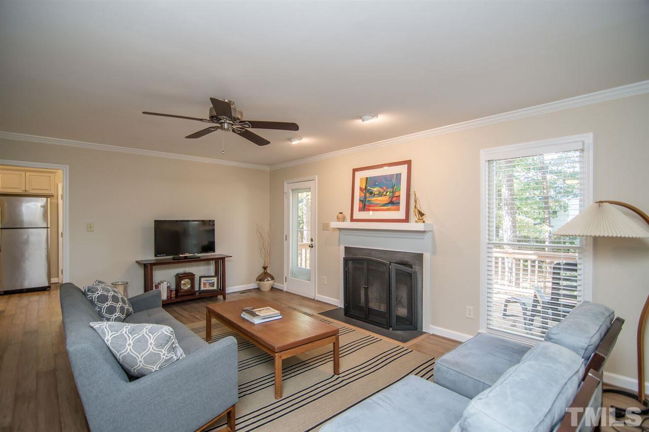 109 Boxford Road Morrisville, NC 27560 - Photo 6 of 27 a living room with furniture a fireplace and a flat screen tv