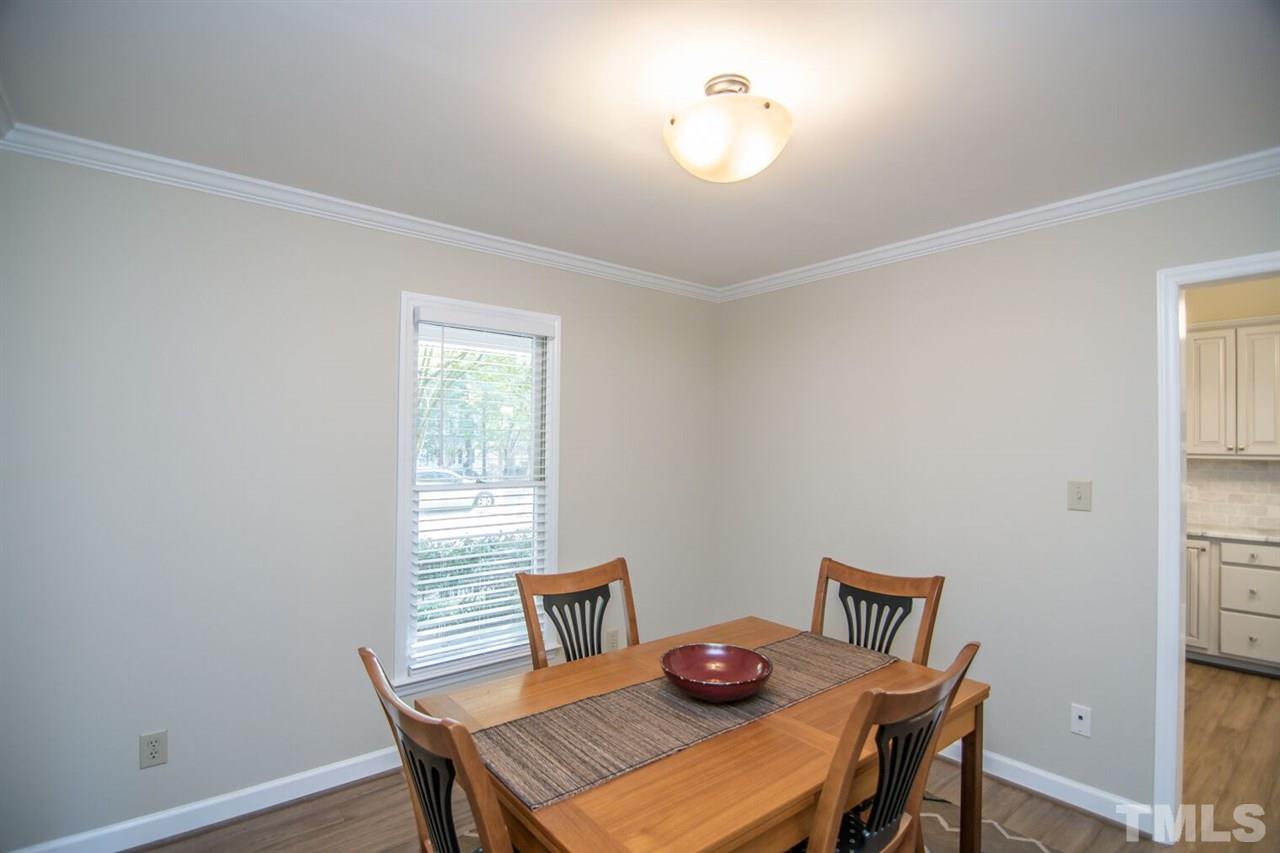 109 Boxford Road Morrisville, NC 27560 - Photo 10 of 27 a view of a dining room with furniture and wooden floor