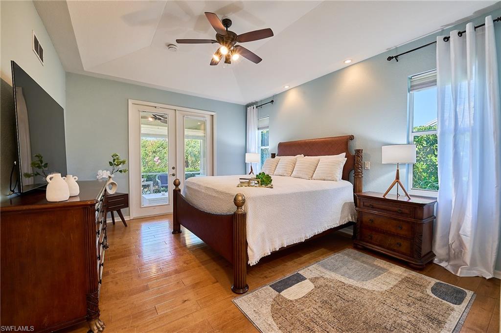 186 Muirfield Circle Naples, FL 34113 - Photo 16 of 36 a bedroom with a bed mirror on desk and a window