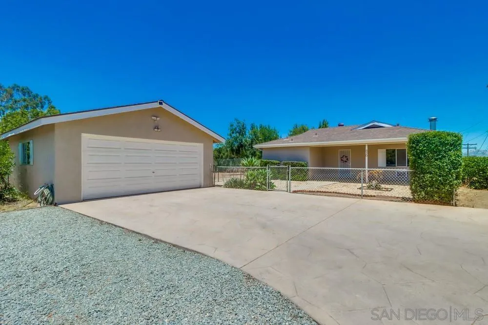 530 Mountain View Road El Cajon, CA 92021 - Photo 2 of 18 a front view of a house with a yard and garage