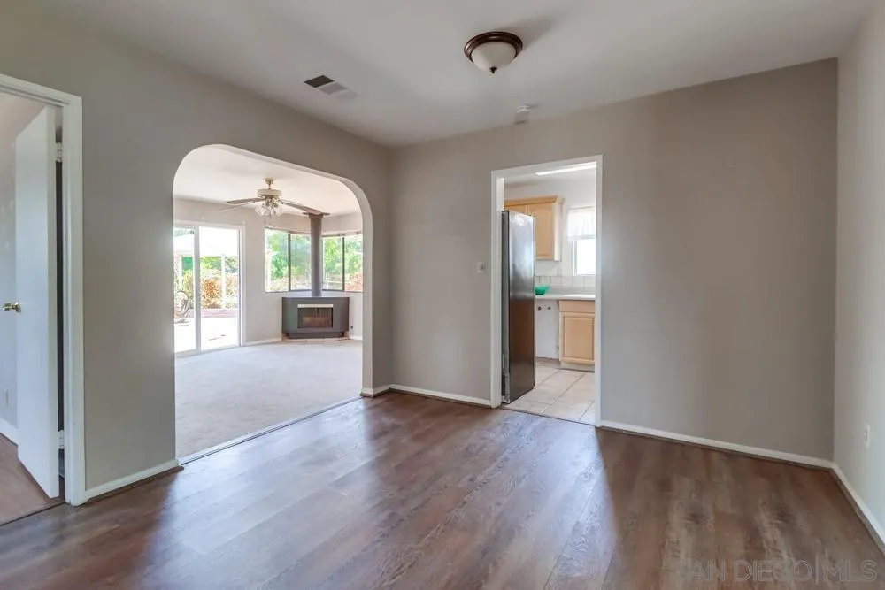 530 Mountain View Road El Cajon, CA 92021 - Photo 6 of 18 an empty room with wooden floor and windows