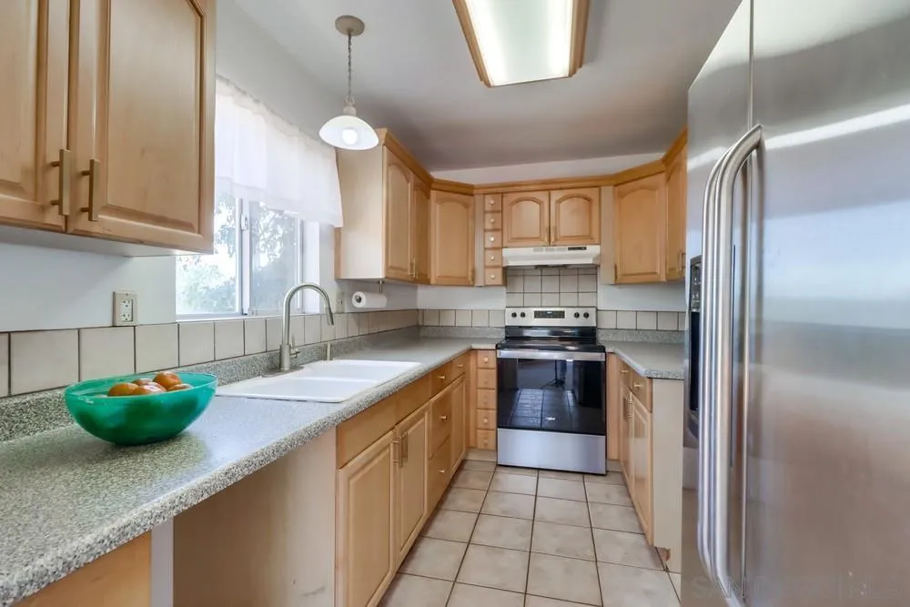 530 Mountain View Road El Cajon, CA 92021 - Photo 7 of 18 a kitchen with stainless steel appliances granite countertop a sink a stove and a refrigerator