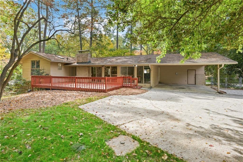 705 Edgewater Trail Sandy Springs, GA 30328 - Photo 34 of 36 a front view of a house with a garden and trees