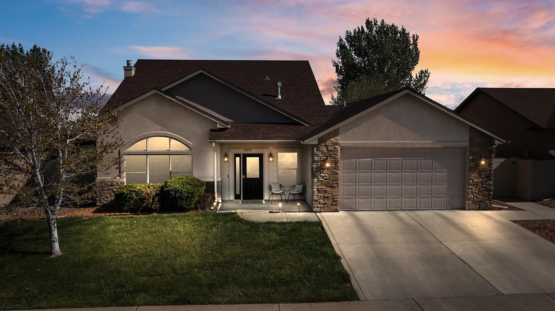 a front view of house with a garden
