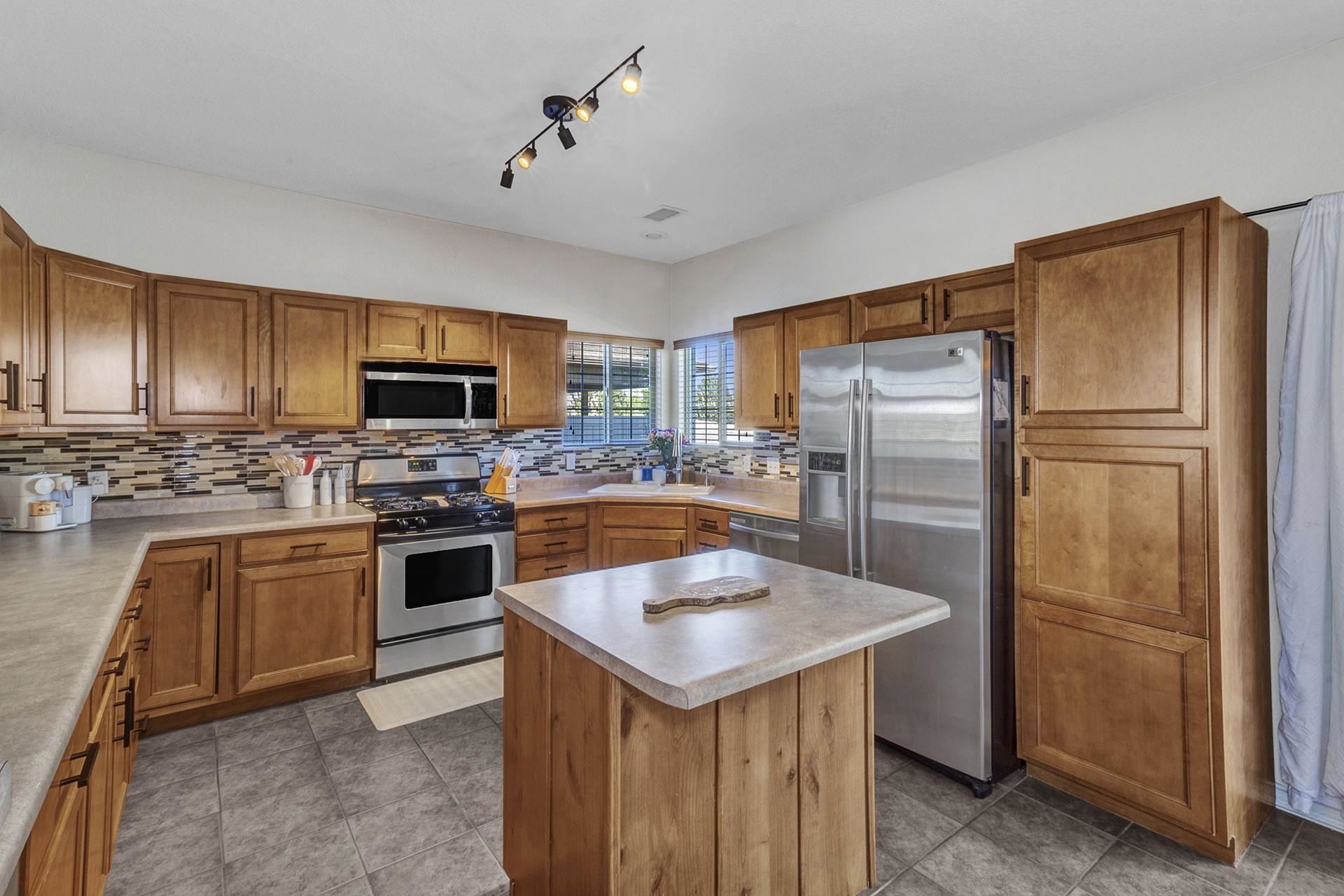 2432 Jack Creek Road Grand Junction, CO 81505 - Photo 11 of 26 a kitchen with a refrigerator stove and sink