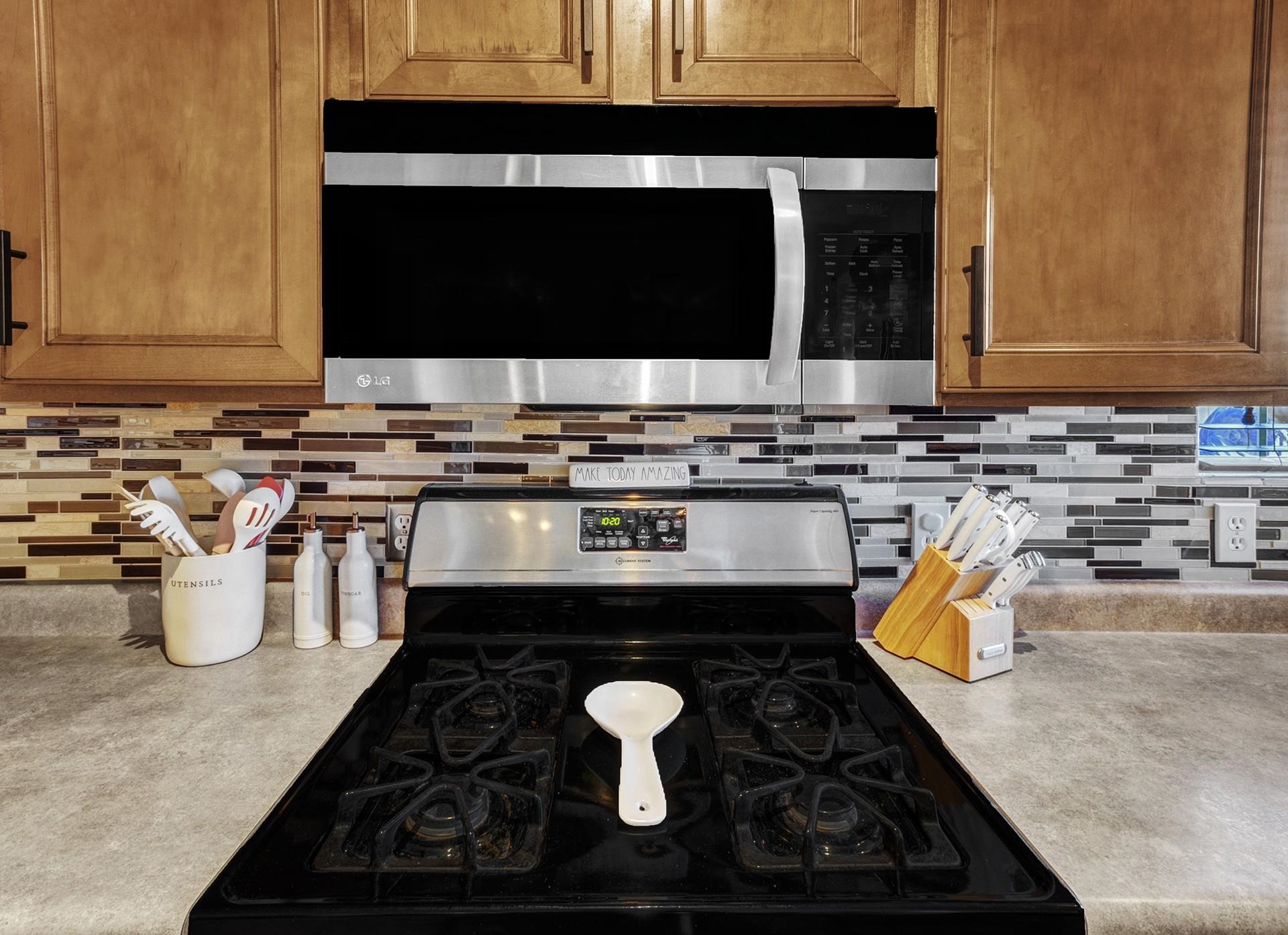 2432 Jack Creek Road Grand Junction, CO 81505 - Photo 13 of 26 a kitchen with a stove and a microwave