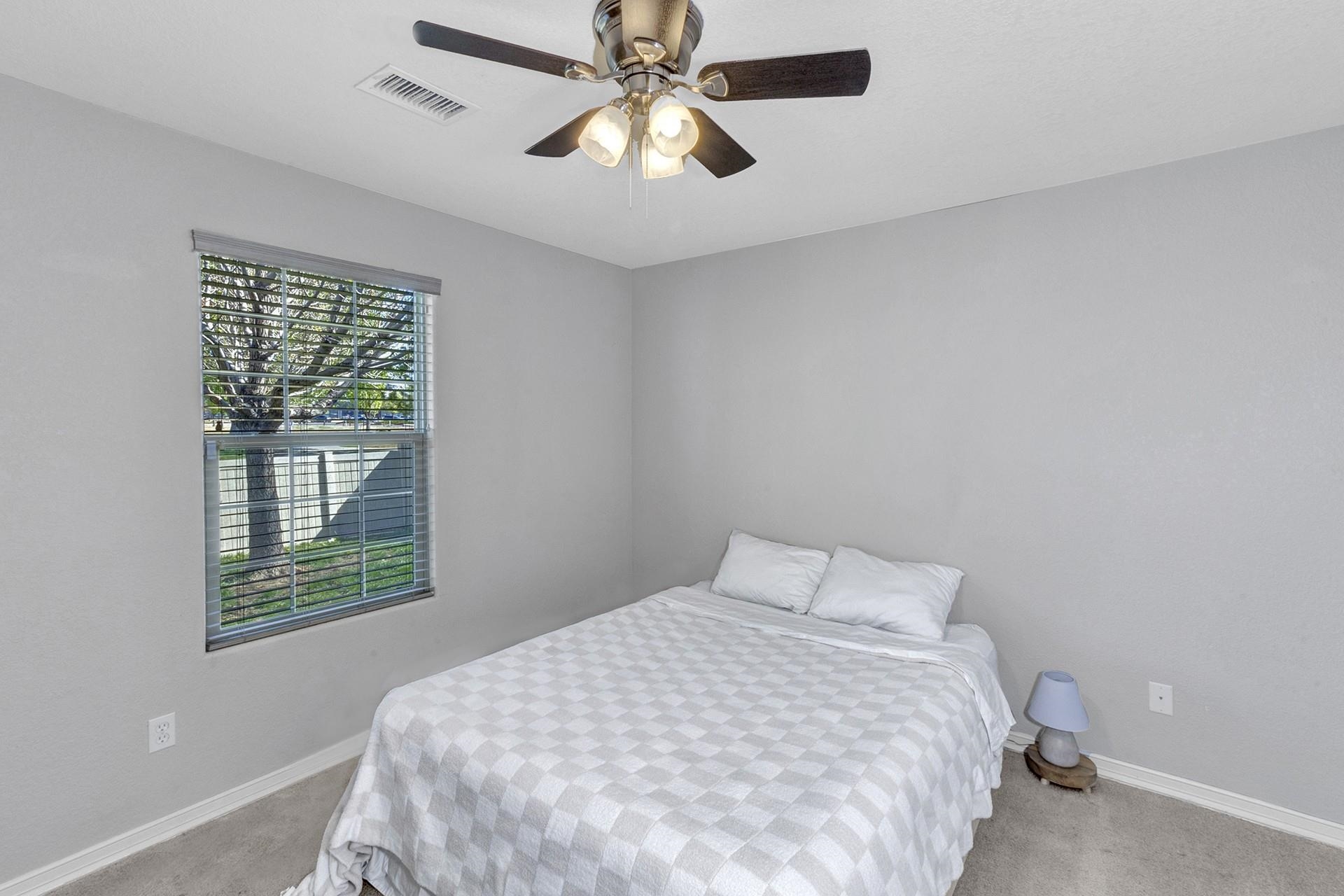 2432 Jack Creek Road Grand Junction, CO 81505 - Photo 15 of 26 a bedroom with a bed and a window