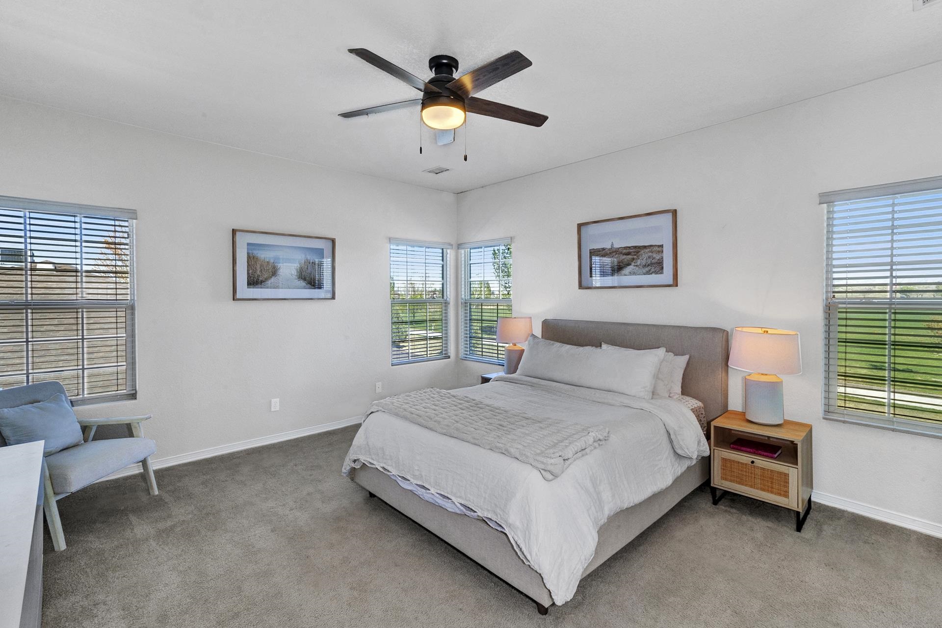2432 Jack Creek Road Grand Junction, CO 81505 - Photo 20 of 26 a spacious bedroom with a bed and a window