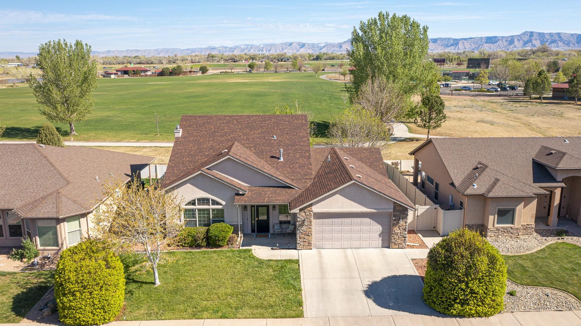 2432 Jack Creek Road Grand Junction, CO 81505 - Photo 2 of 26 an aerial view of a house with big yard and large tree