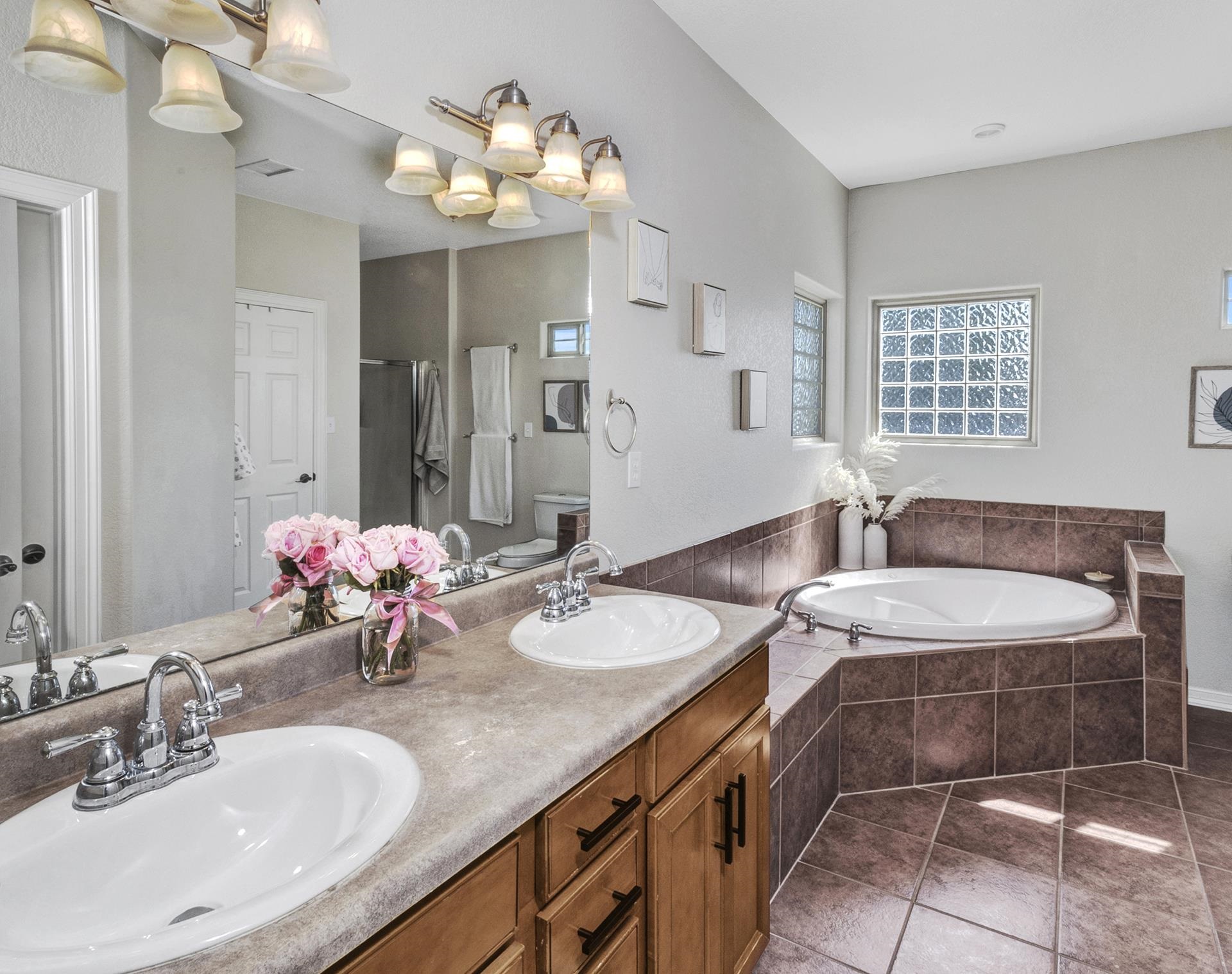 2432 Jack Creek Road Grand Junction, CO 81505 - Photo 22 of 26 a bathroom with a granite countertop sink a large mirror and a bathtub