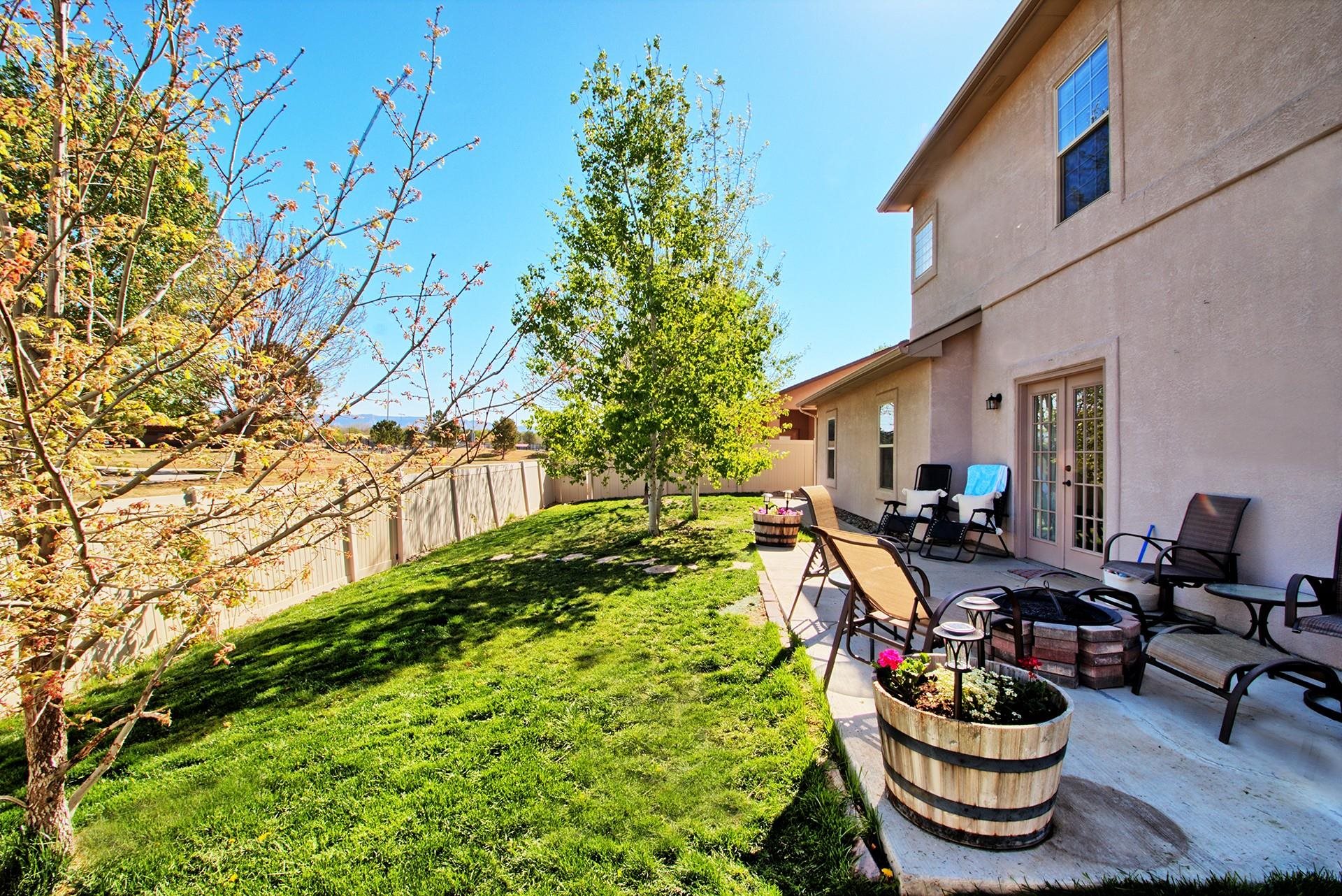 2432 Jack Creek Road Grand Junction, CO 81505 - Photo 25 of 26 a view of a backyard with plants and a patio