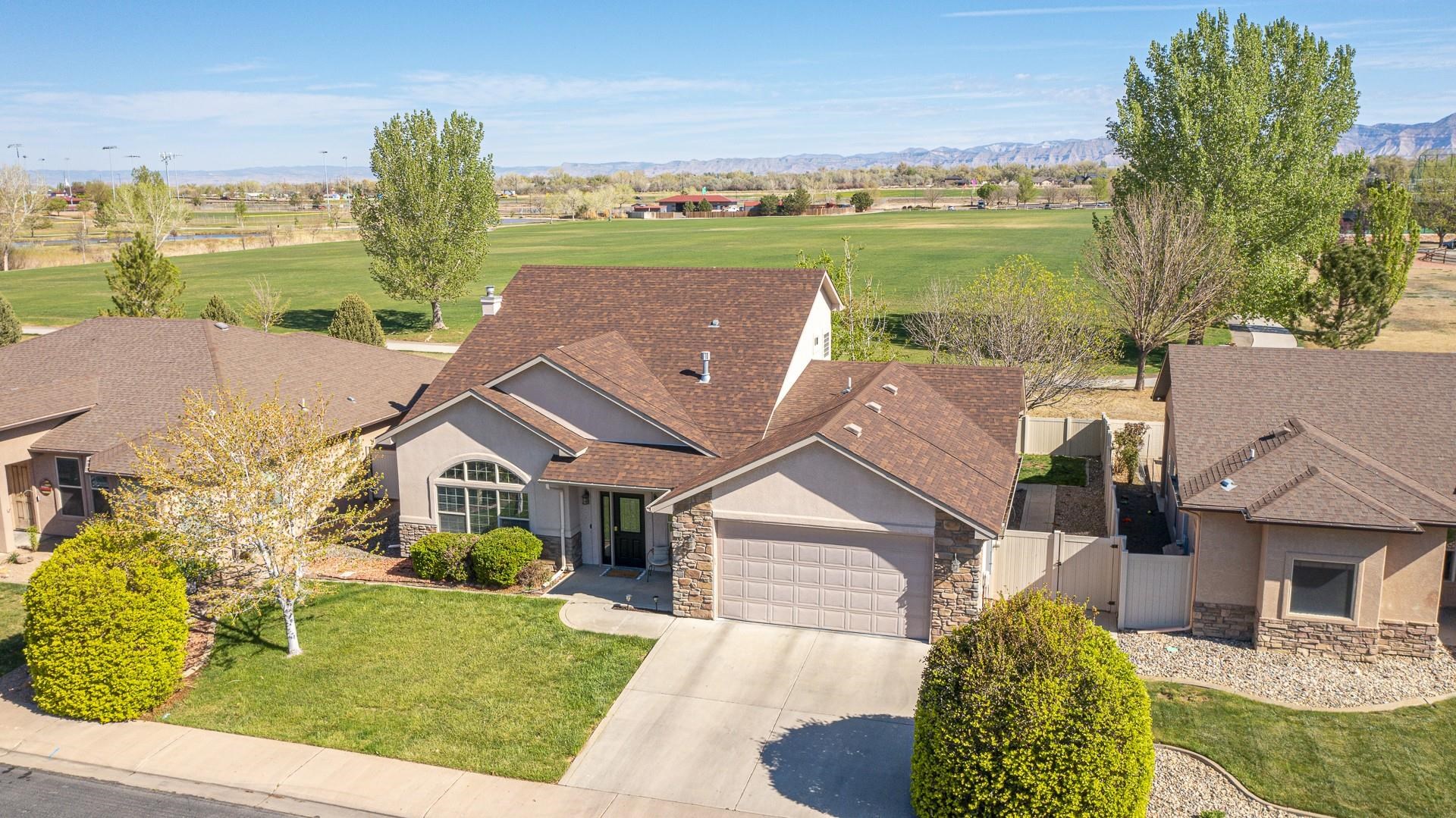 2432 Jack Creek Road Grand Junction, CO 81505 - Photo 3 of 26 an aerial view of a house with a garden and lake view