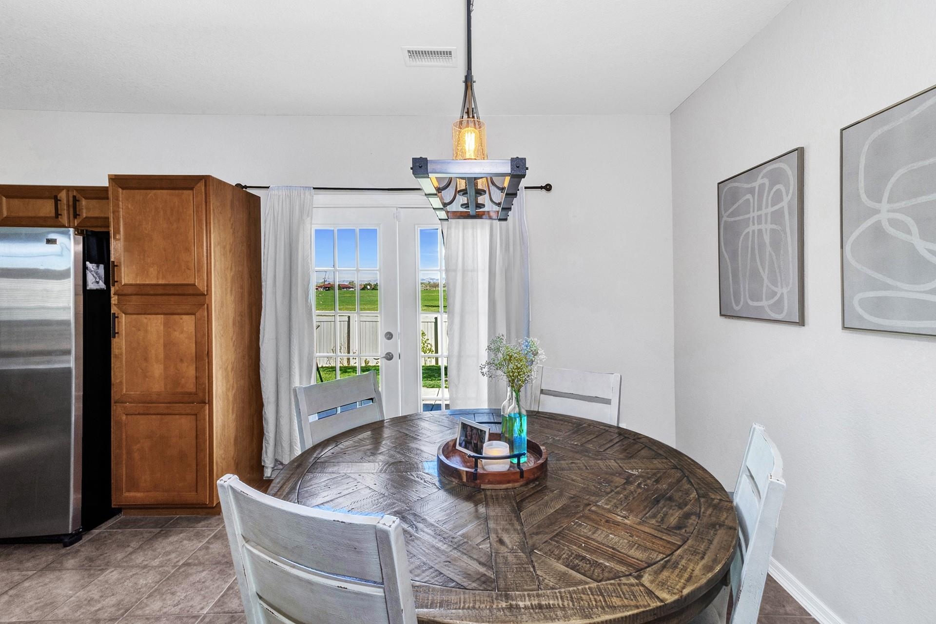 2432 Jack Creek Road Grand Junction, CO 81505 - Photo 9 of 26 a dining room with furniture and a chandelier