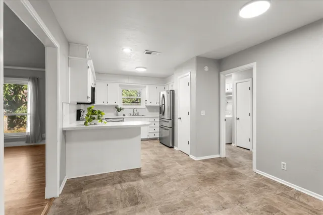 a kitchen with a refrigerator and a stove