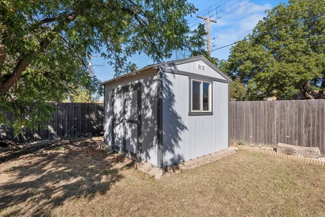 a view of a backyard with large trees