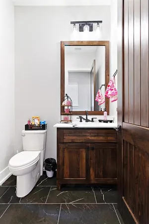 a bathroom with a sink toilet and mirror