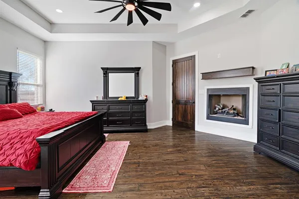 a living room with a bed and a fireplace