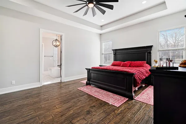 a bedroom with a bed and a chandelier