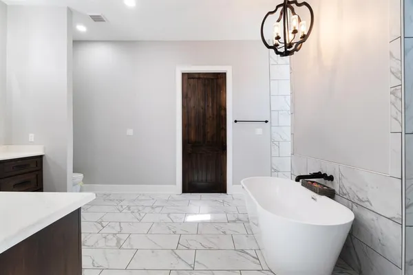 a bathroom with a bathtub and shower