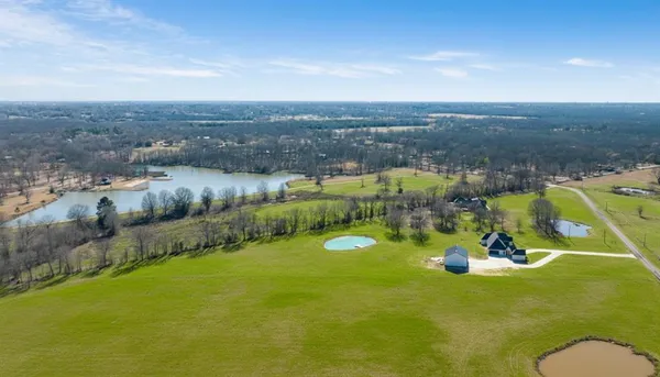 an aerial view of a residential houses with outdoor space and swimming pool