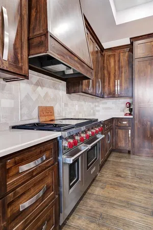 a kitchen with a stove and a refrigerator