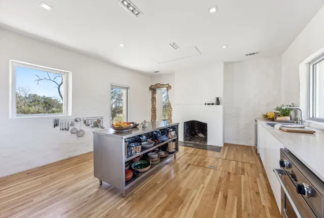 a view of a kitchen with furniture and wooden floor