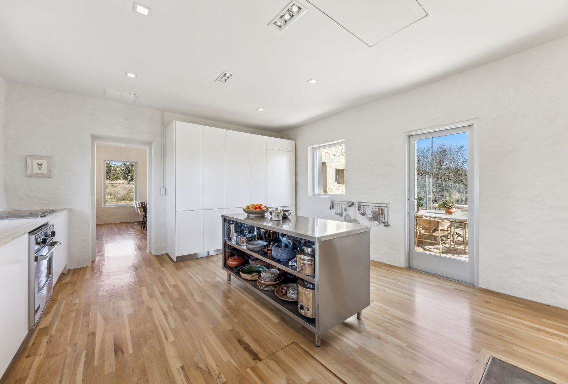 1037 Ranch Road 962 West Round Mountain, TX 78663 - Photo 12 of 40 a view of a kitchen with furniture and wooden floor