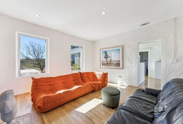 a living room with fireplace furniture and a flat screen tv