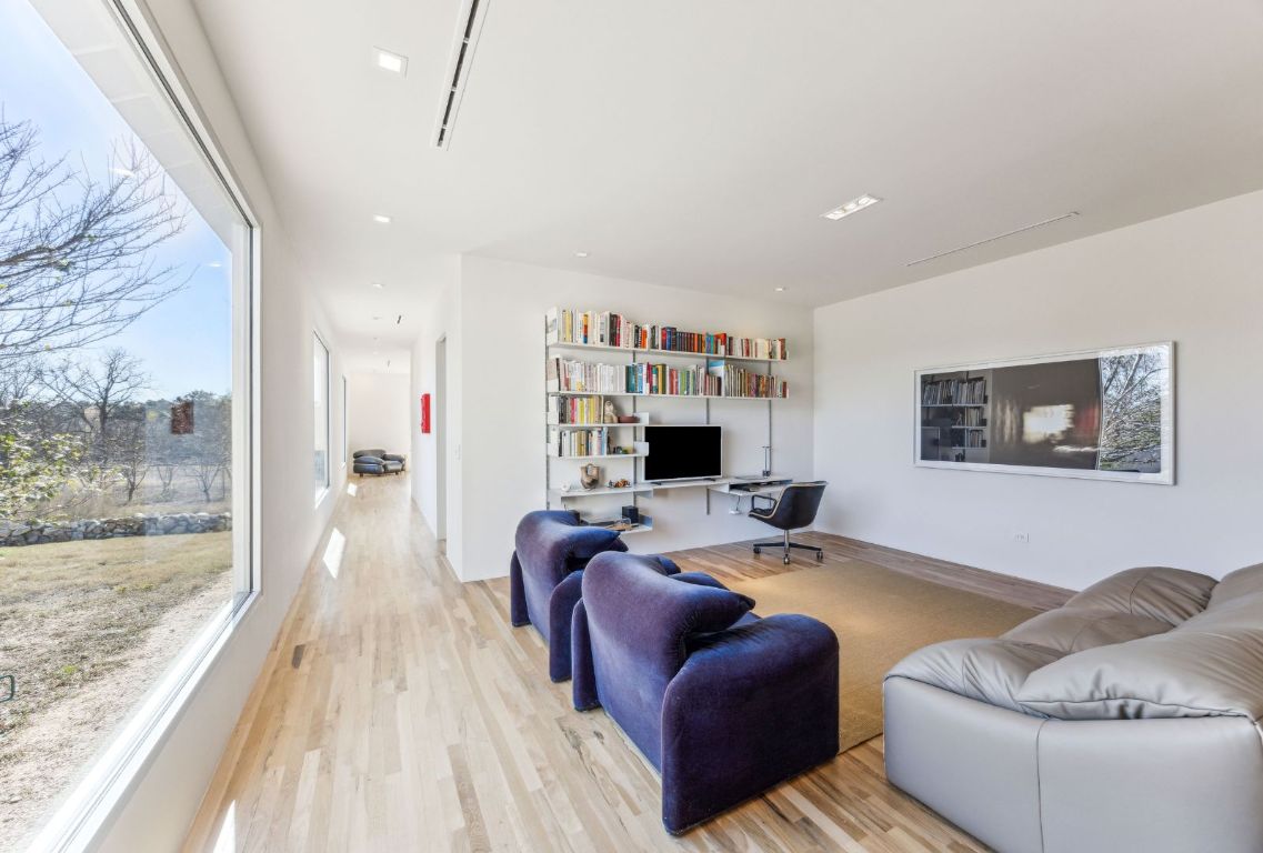 1037 Ranch Road 962 West Round Mountain, TX 78663 - Photo 16 of 40 a living room with furniture a flat screen tv and a floor to ceiling window
