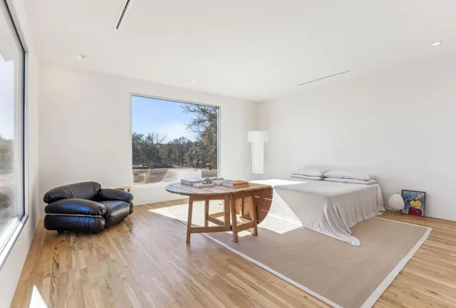 a bedroom with a bed and a painting on the wall