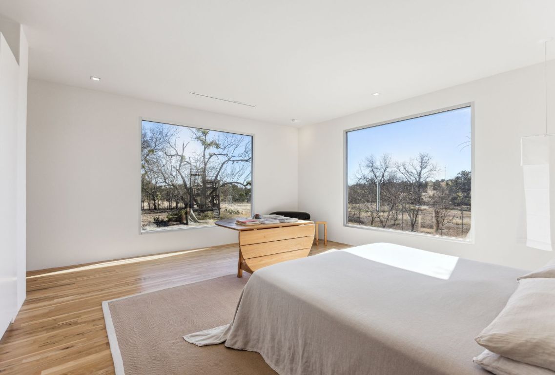 1037 Ranch Road 962 West Round Mountain, TX 78663 - Photo 18 of 40 a bedroom with a bed and a painting on the wall
