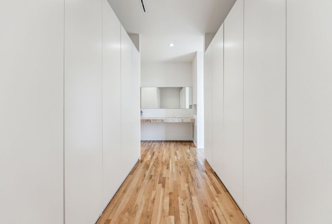 1037 Ranch Road 962 West Round Mountain, TX 78663 - Photo 19 of 40 a view of a hallway with wooden floor and a bathroom