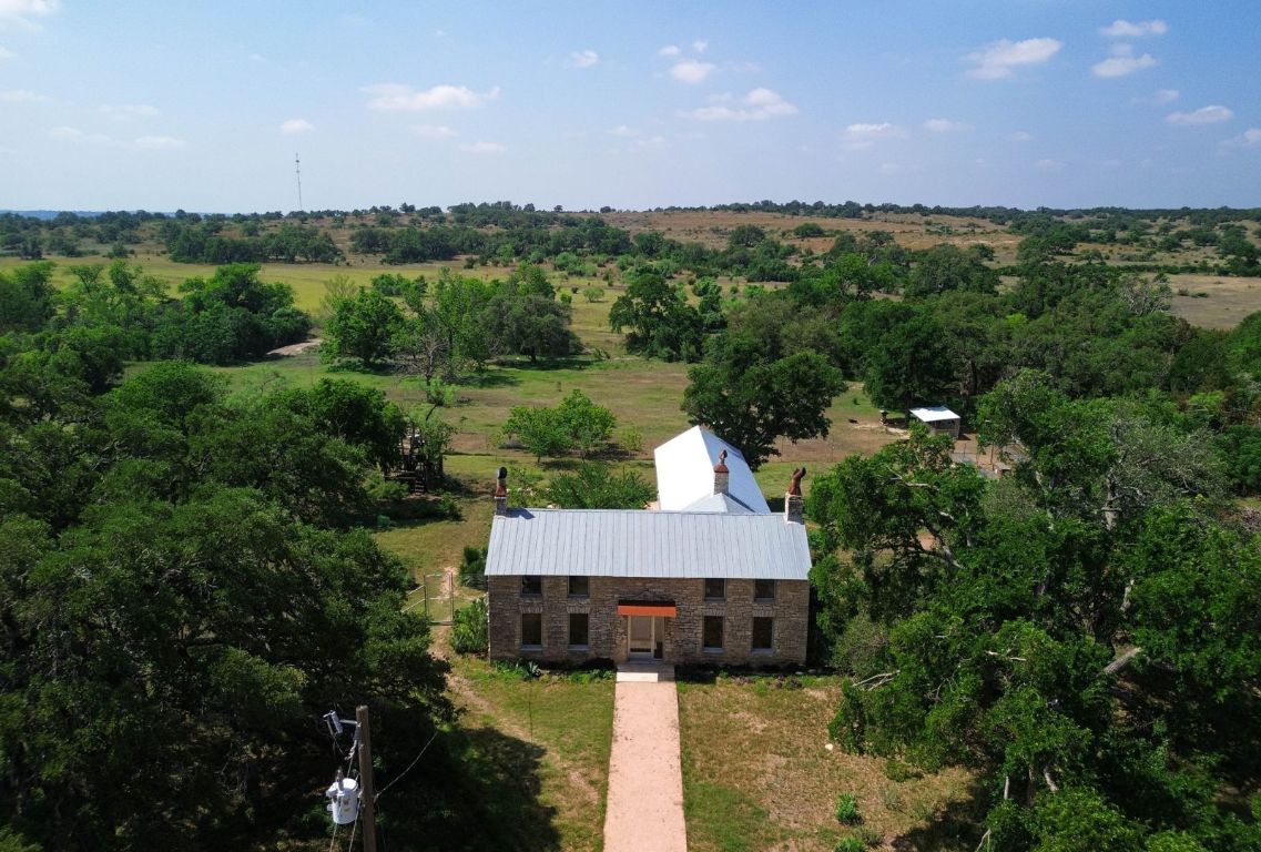 1037 Ranch Road 962 West Round Mountain, TX 78663 - Photo 2 of 40 a view of a house with a yard and lake view
