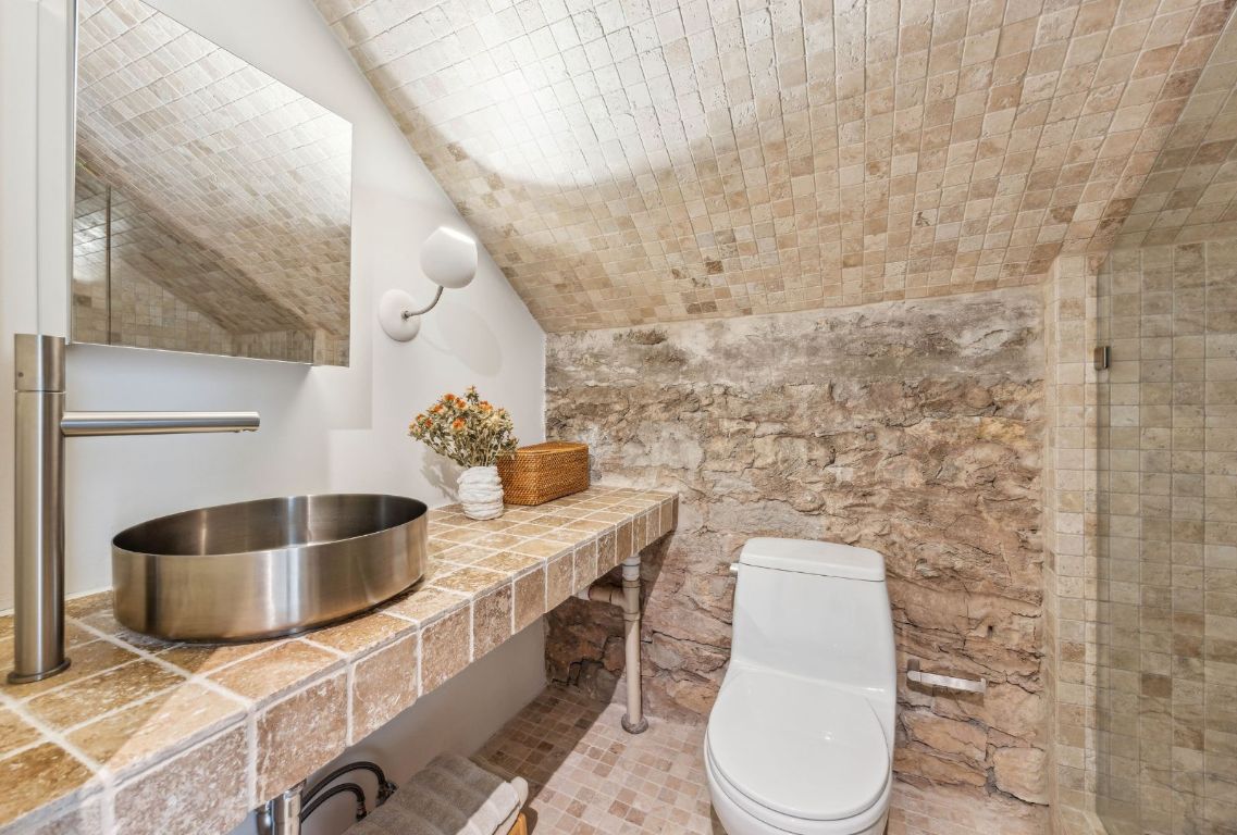 1037 Ranch Road 962 West Round Mountain, TX 78663 - Photo 26 of 40 a bathroom with a toilet sink and mirror
