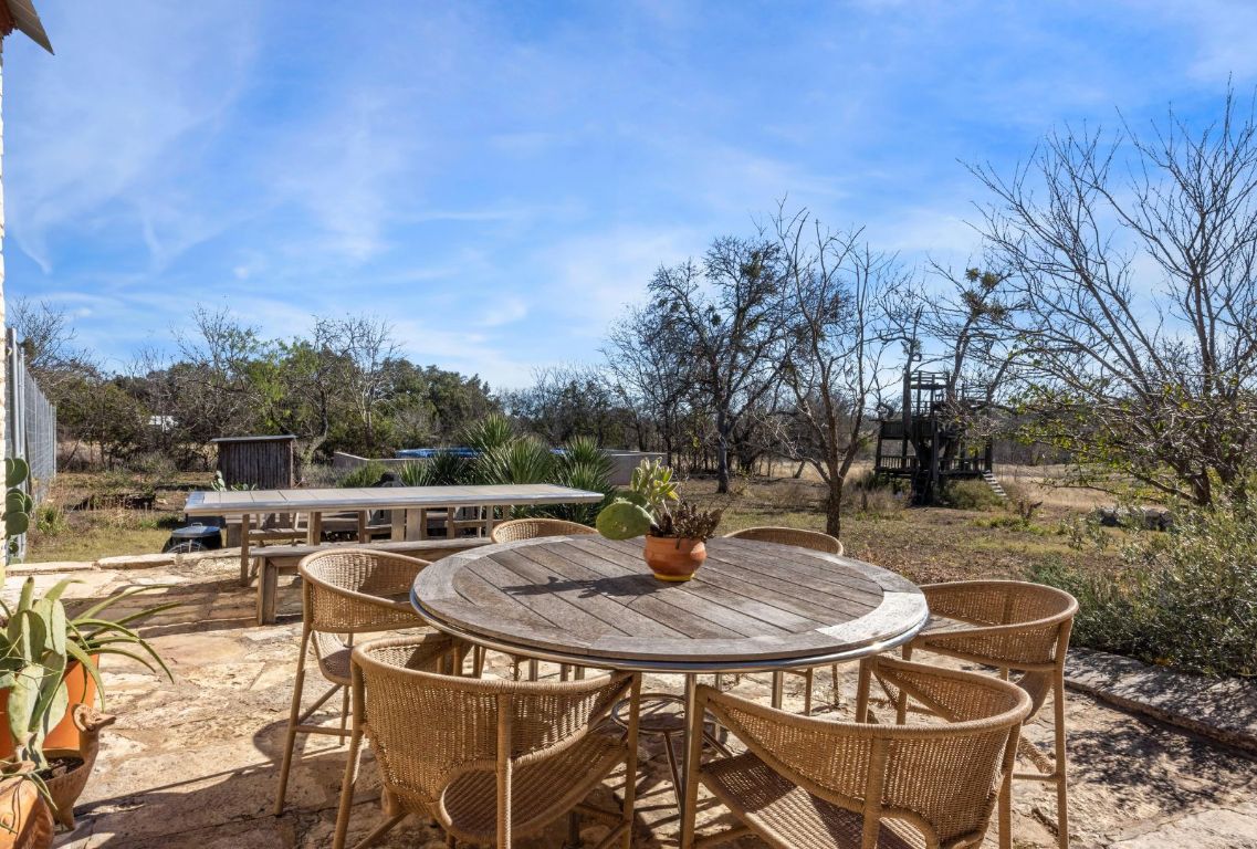 1037 Ranch Road 962 West Round Mountain, TX 78663 - Photo 31 of 40 a view of backyard with seating space and trees
