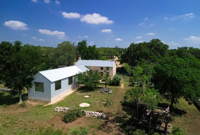 an aerial view of a house with a garden and a yard