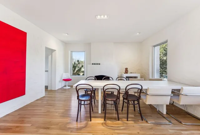 a view of a a dining room with furniture window and wooden floor